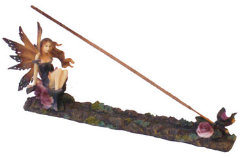 A side view of the Dark Fairy & Flowers Incense Burner depicts a sculpted fairy amidst flowers, forming a dark, decorative incense holder. - Dark Fairy & Flowers Incense Burner
