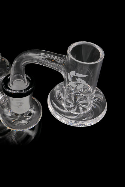 Clear glass cannabis dab rig with intricate swirling patterns and handle, isolated on a black background.