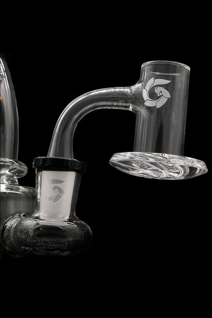 Clear glass dab rig with intricate curves and a visible water line, against a black background.