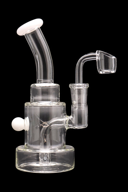 Clear glass dab rig with a quartz banger and colorful accents.