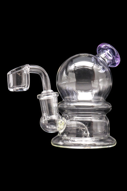 Clear glass dab rig with a quartz banger and purple accent.