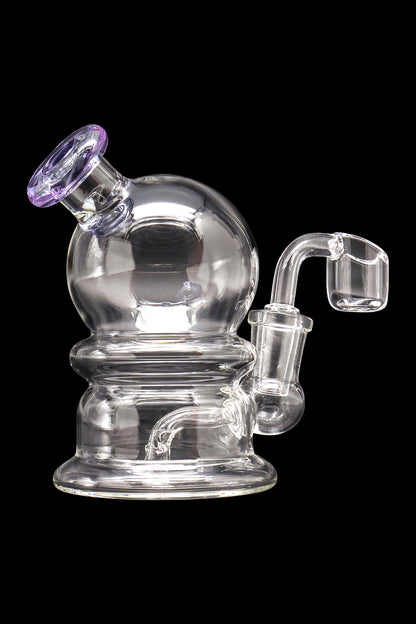 Clear glass water pipe (rig) with a quartz banger, isolated on a black background.