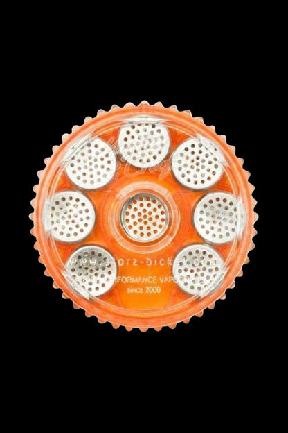 Overhead view of the Storz & Bickel Magazine, displaying eight circular dosing capsules arranged within its pale orange housing.