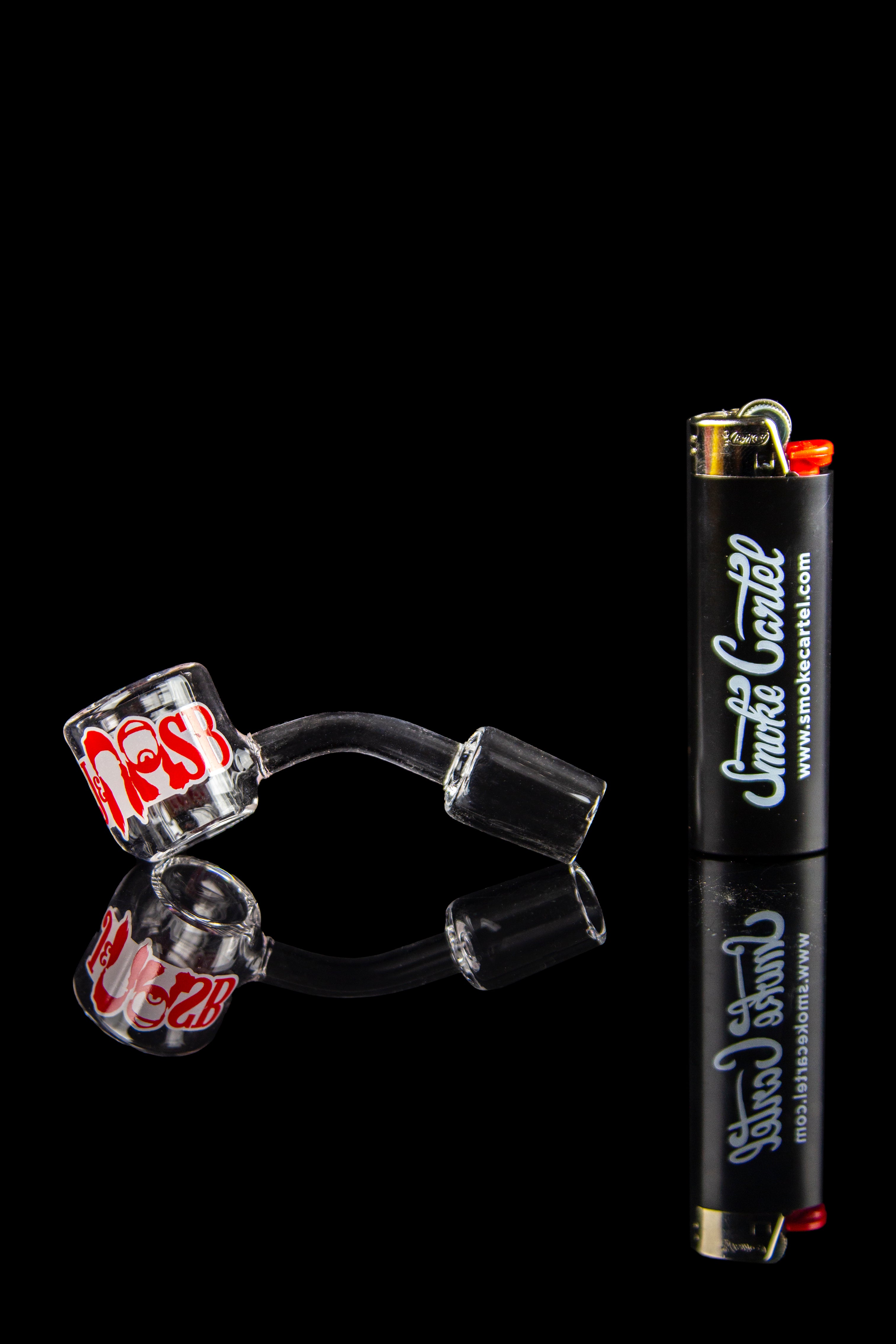 Glass cannabis smoking pieces and lighter against a black background.