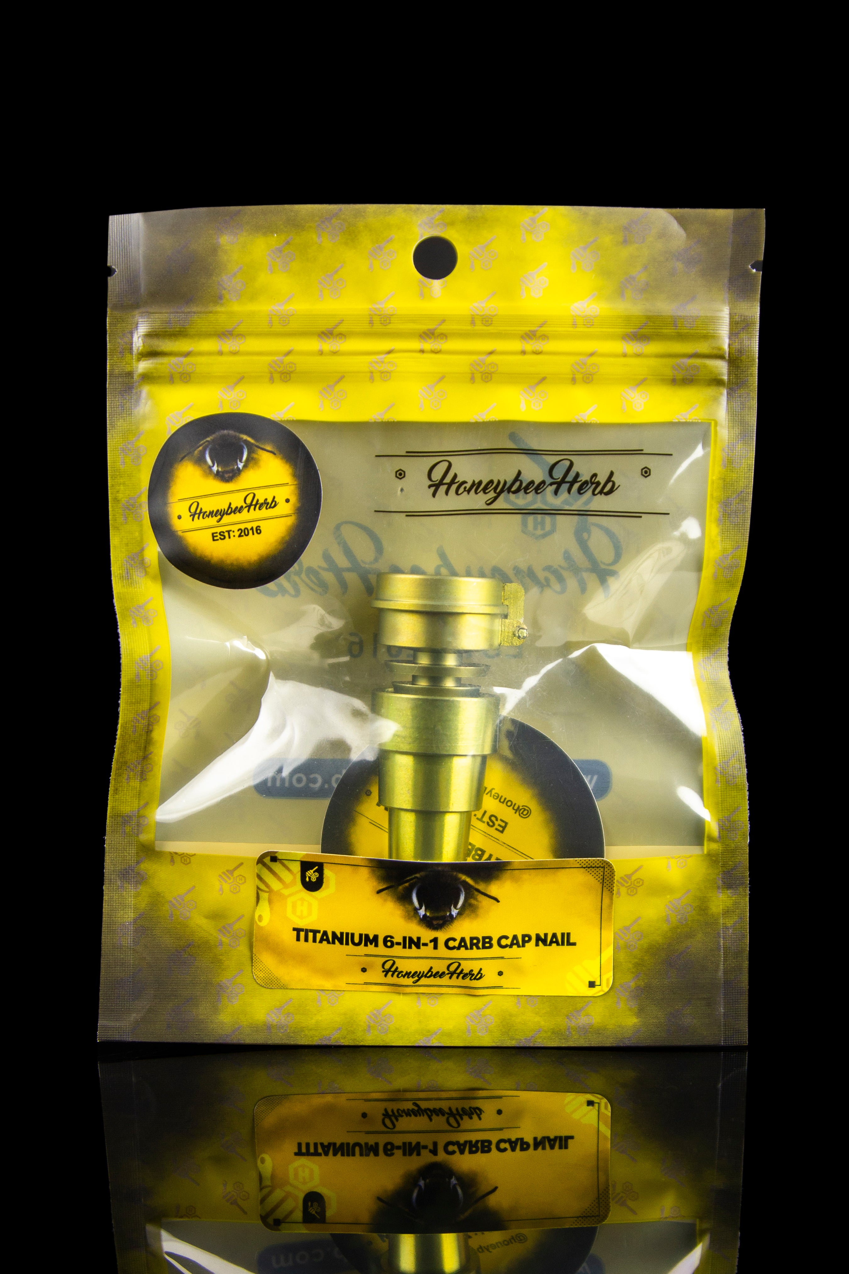 Gold mylar bag with “Honeybee Herb” branding and a titanium 6-in-1 carb cap inside, designed for cannabis concentrates.