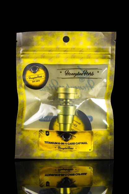 Gold mylar bag with “Honeybee Herb” branding and a titanium 6-in-1 carb cap inside, designed for cannabis concentrates.
