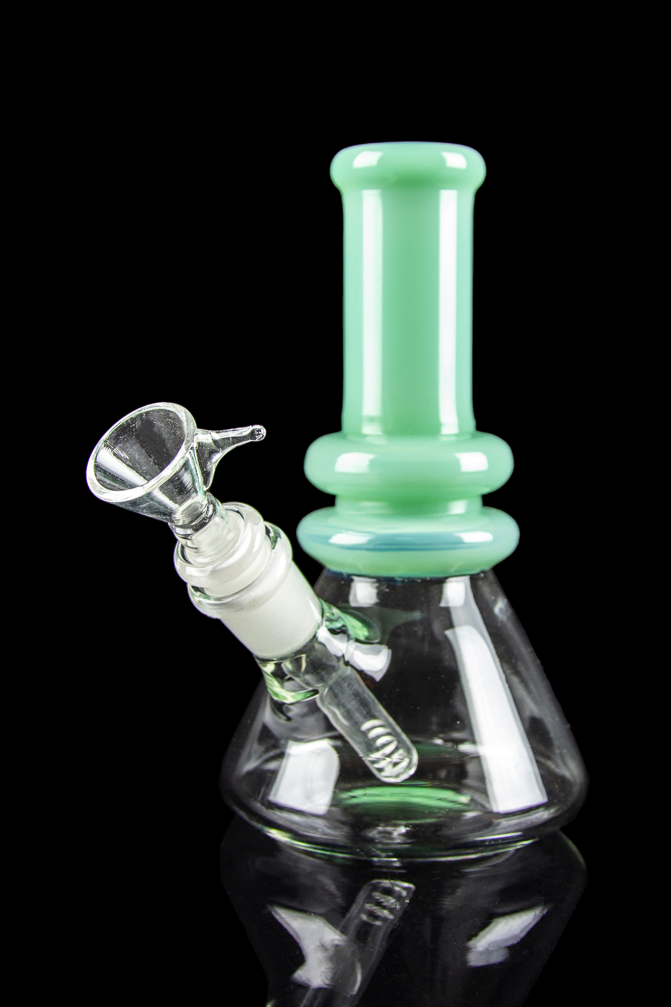 A green glass water pipe (bong) with a clear glass bowl, isolated on a black background.