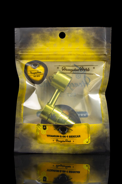 Gold pouch displaying a “HoneybeeHerb” branded titanium 6-in-1 sidecar for cannabis concentrates.