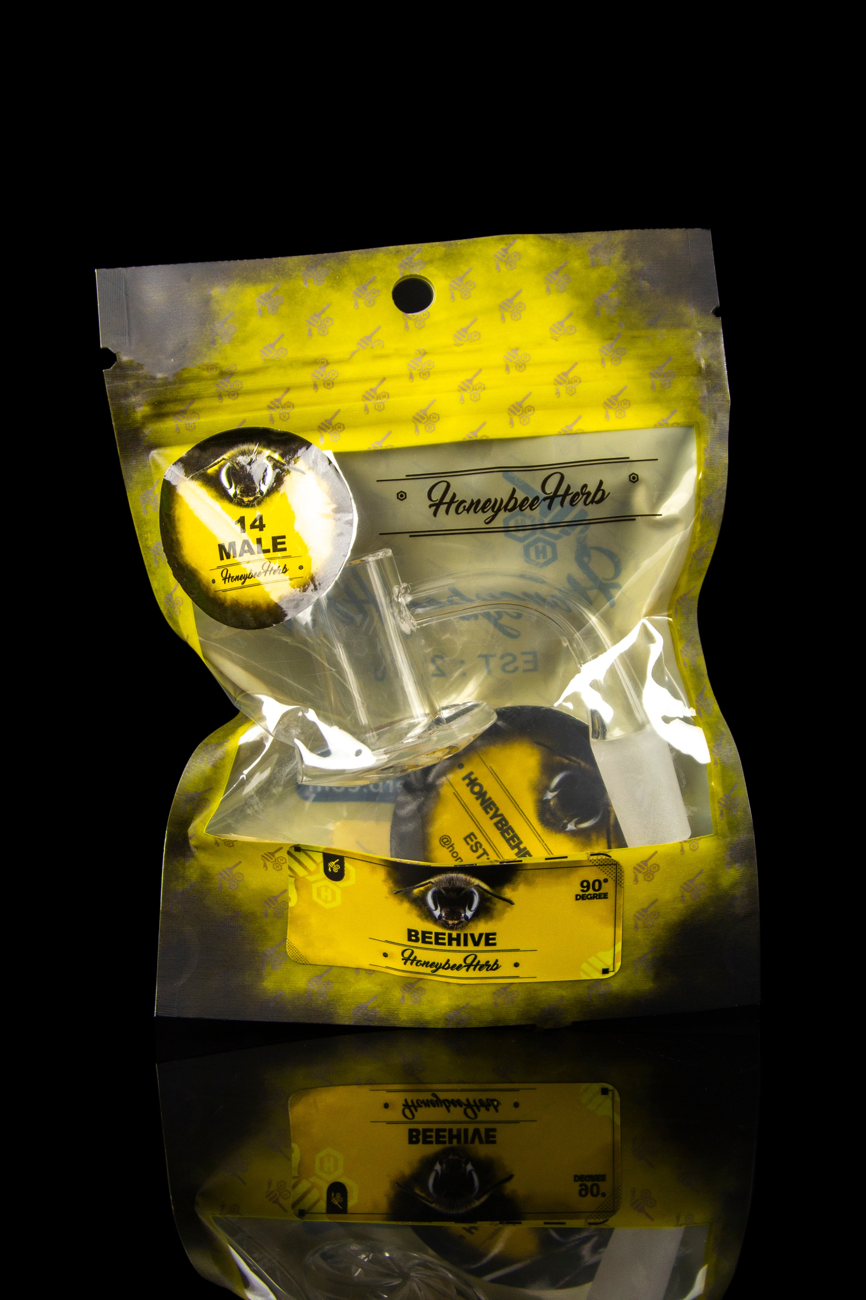 Gold mylar bag containing cannabis accessories, including a pipe, lighter, and branded packaging from Honeybee Herb.
