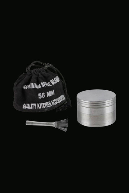 A close-up of the Classic 4-Piece Metal Grinder, showing its silver, multi-tiered cylindrical design against a dark backdrop.