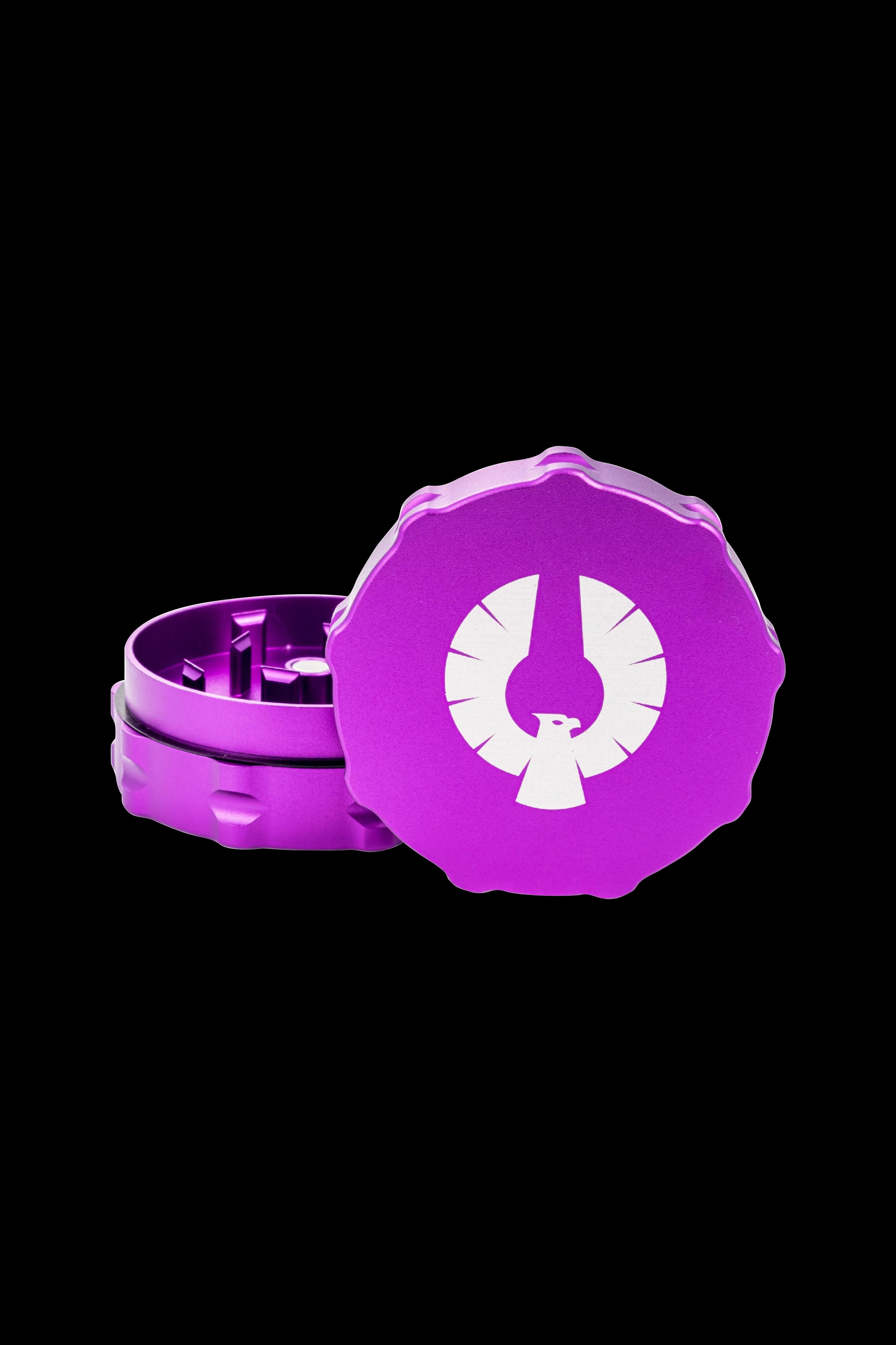 Purple cannabis grinder with a white phoenix logo, open to reveal the grinding teeth.