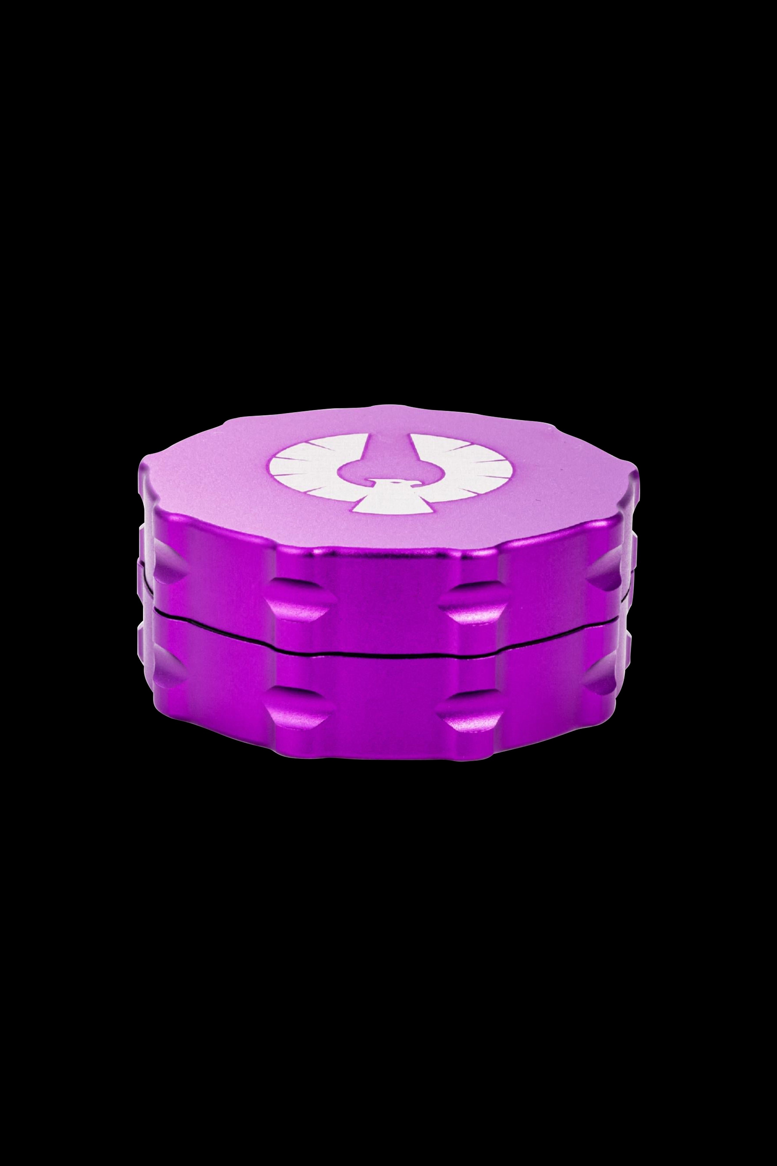 Purple four-piece cannabis grinder with a white logo.