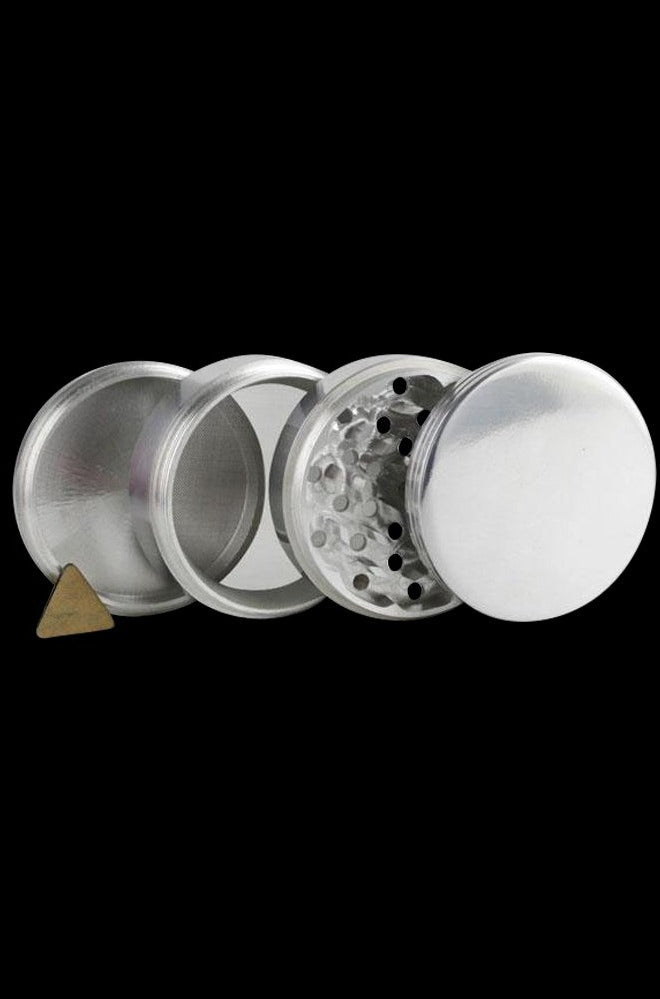 A disassembled Metal 4-Piece Grinder, showing its four silver metal sections arranged in a circular view.