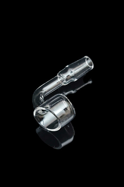 Clear glass dab rig component against a black background.