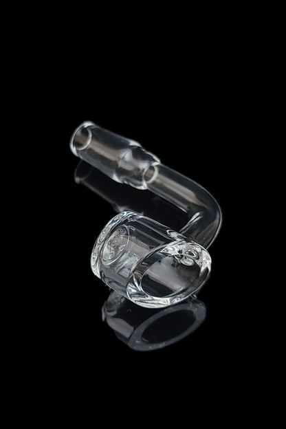 Clear glass oil rig with a rounded base and angled mouthpiece, isolated on black.