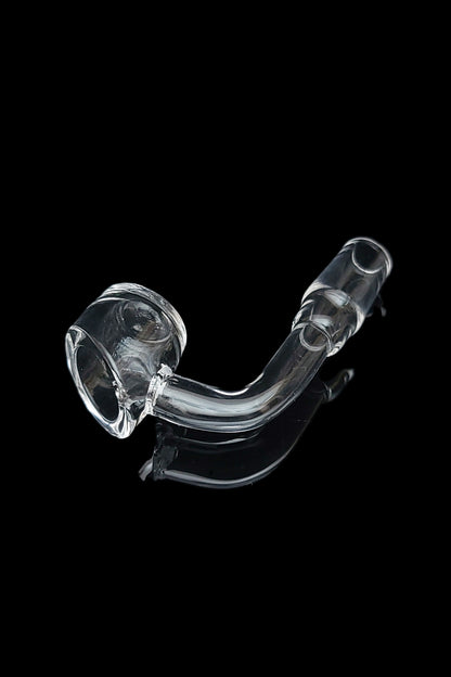 Clear glass oil rig for dabbing cannabis concentrates against a black background.