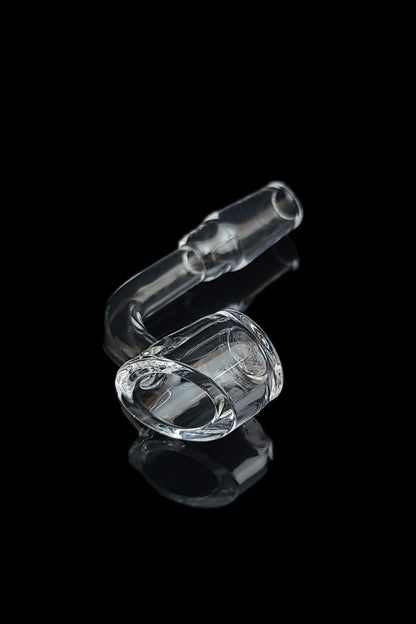 Clear glass oil rig with a rounded chamber, reflecting on a dark surface.