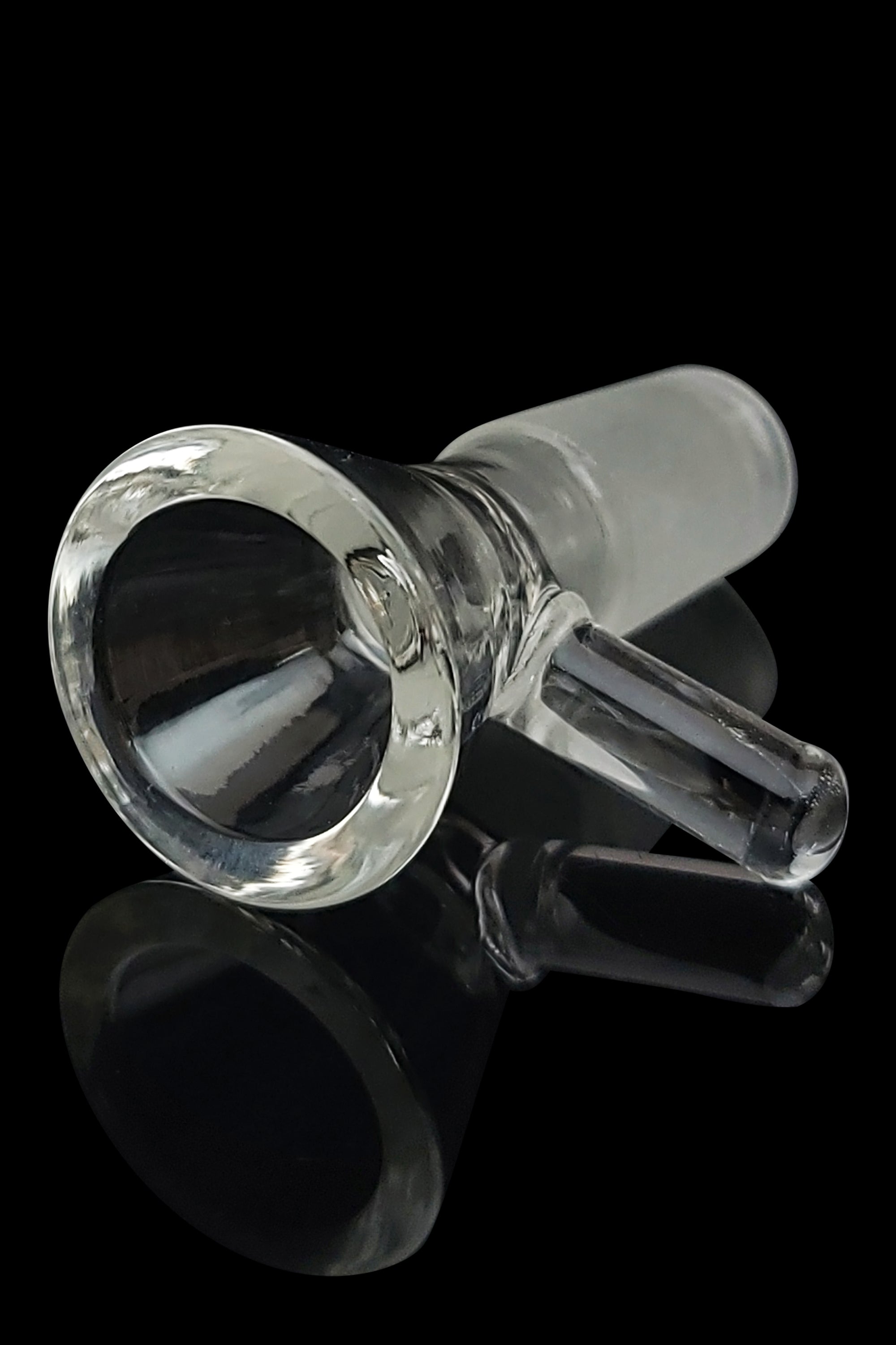 Clear glass cannabis bowl with downstem, reflecting on a black surface.