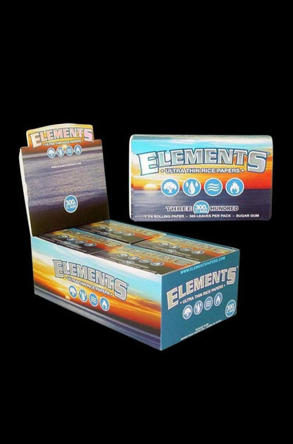 A close-up, slightly angled shot of the Elements Ultra Thin 1 1/4" Rice Rolling Papers packaging, displaying the brand logo and colorful design.