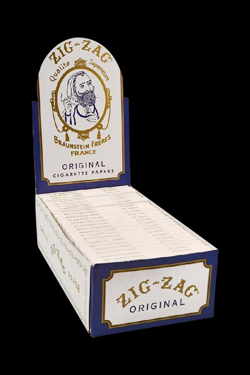 A front view of the Zig Zag White Single Wide Rolling Papers - 24 Pack, showing the white packaging with vintage-style branding.
