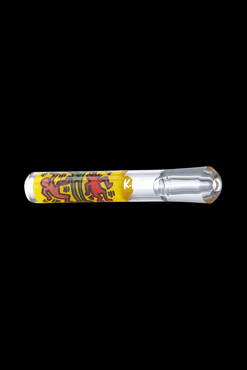 A side view of the K.Haring Taster Chillum Pipe, featuring colorful artwork on clear glass.