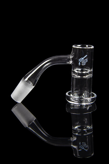 Clear glass dab rig with a bent neck and accompanying nail, reflected on a black surface.