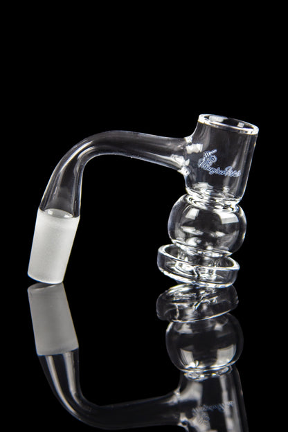 Clear glass bubbler with bulbous chambers and a bent mouthpiece, reflected on a black surface.