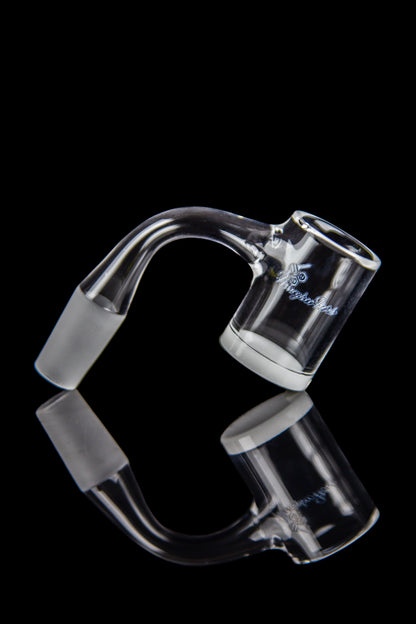 Clear glass cannabis oil rig banger with reflective surface.