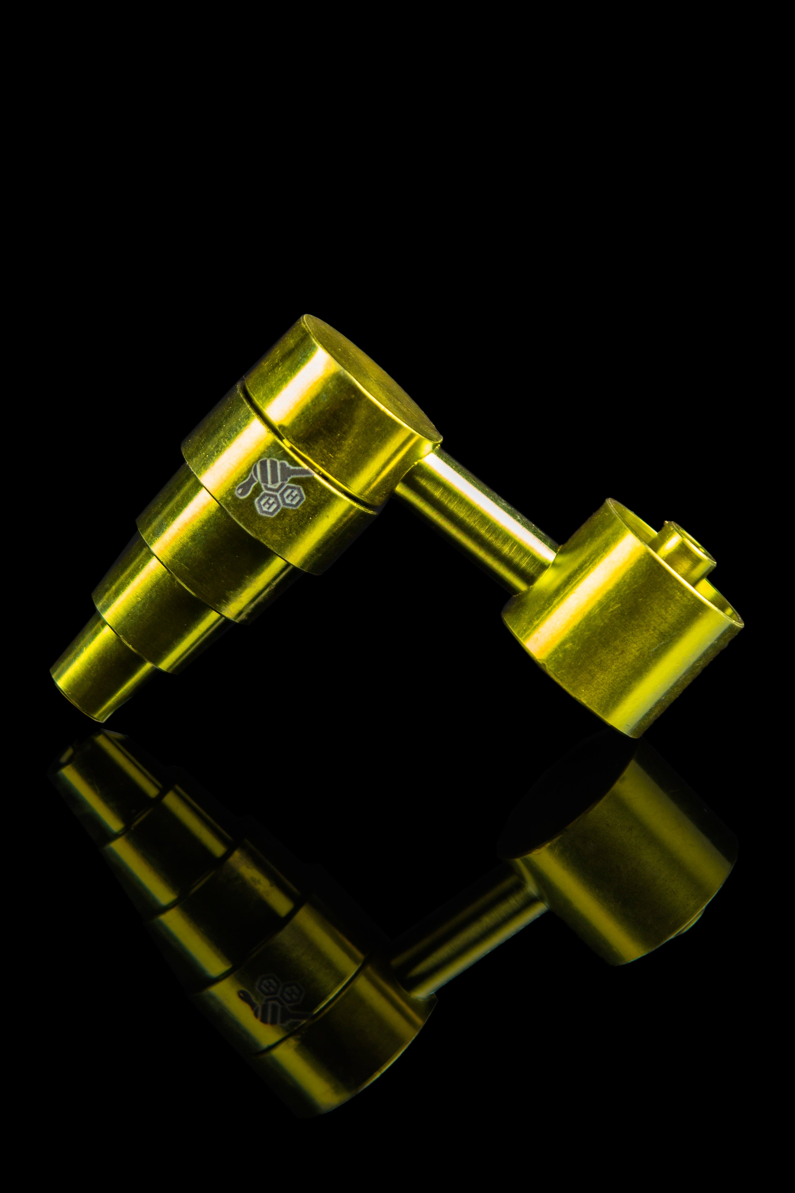 Gold cannabis dab rig with a reflective surface.