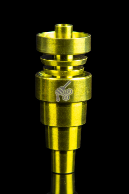 Gold-colored dab rig with etched design against a black background.