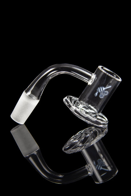 Clear glass dab rig attachment with intricate swirling design and frosted joint, reflected on a black surface.