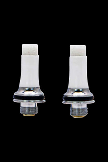Two white cannabis vape cartridge attachments against a black background.