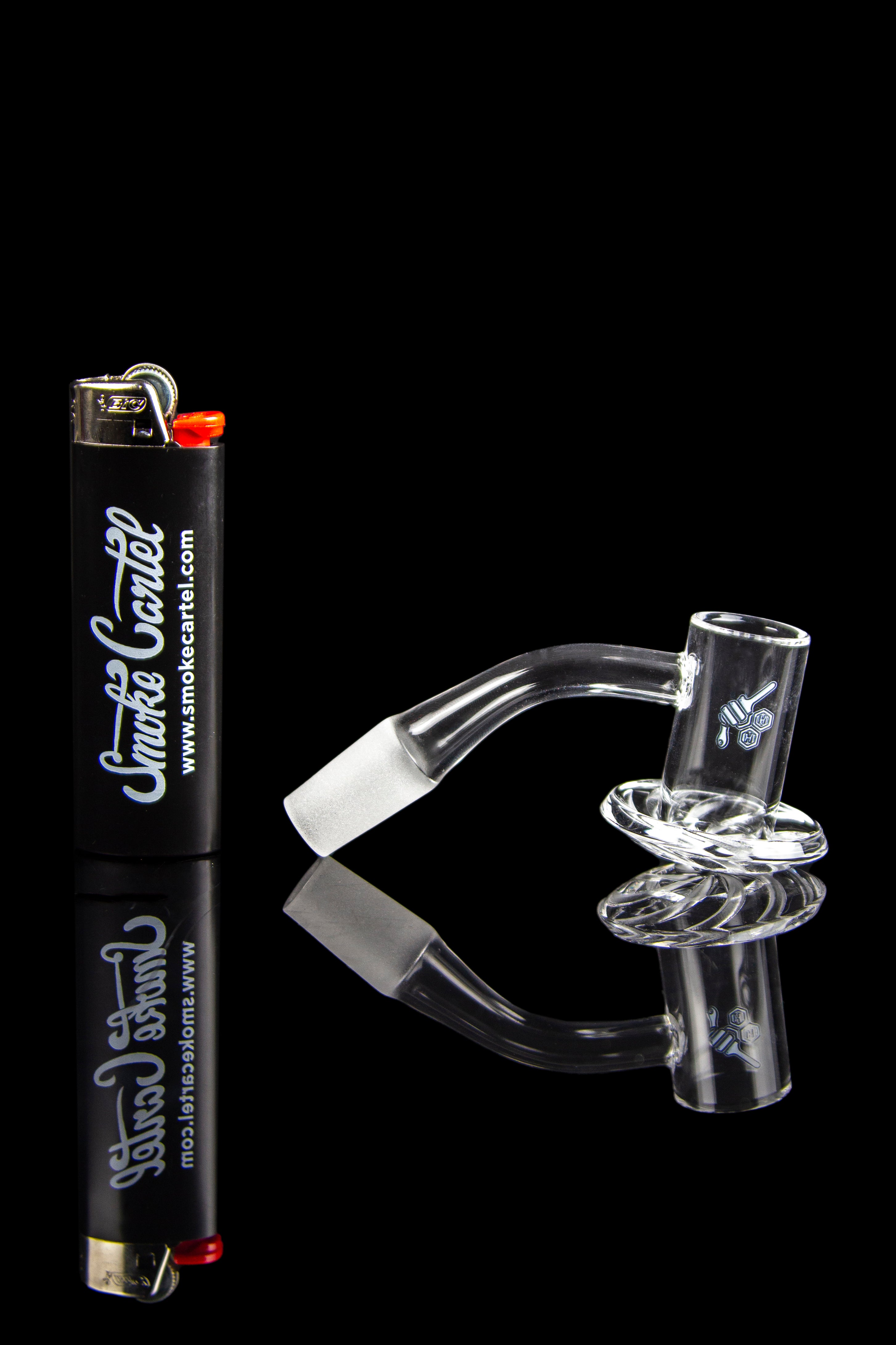 Glass water pipe and lighter on a reflective surface.