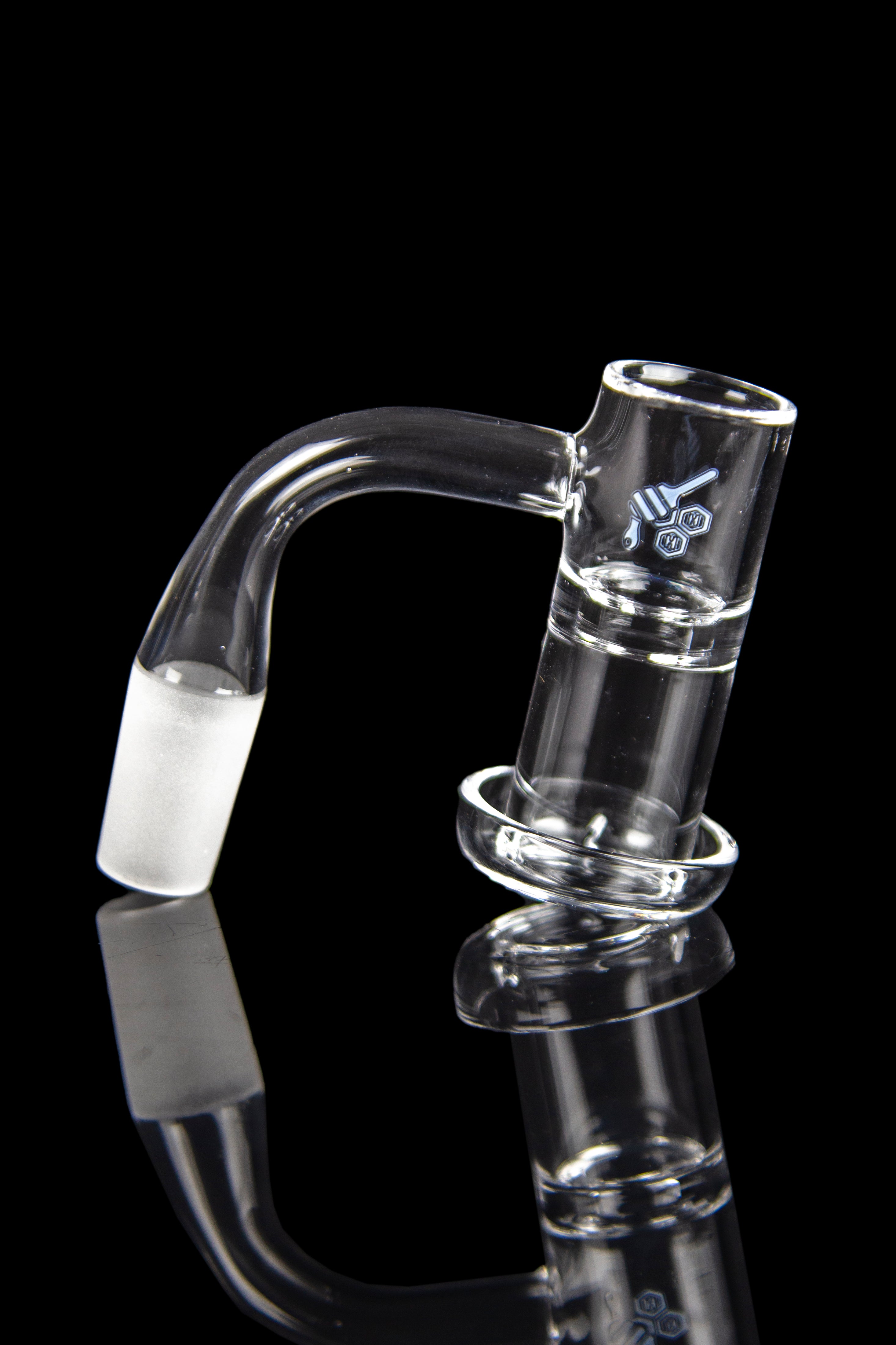 Clear glass dab rig with curved mouthpiece and reflective surface.