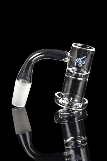 Clear glass dab rig with curved mouthpiece and reflective surface.