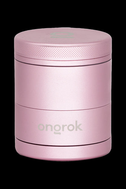 Pink metal cannabis grinder with “ongrok” logo.