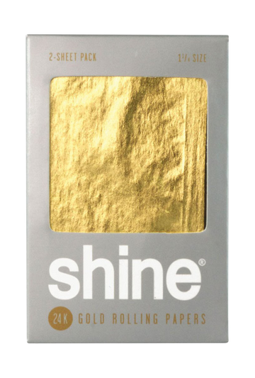 Front view of the Shine 24K Gold 1 1/4" Rolling Papers package, featuring a gold, textured surface. - Shine 24K Gold 1 1/4"Rolling Papers - 2 Pack