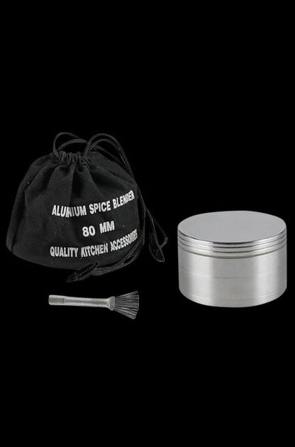 A close-up of the Metal 4-Piece Grinder, showcasing its silver metallic finish and cylindrical multi-tiered design.