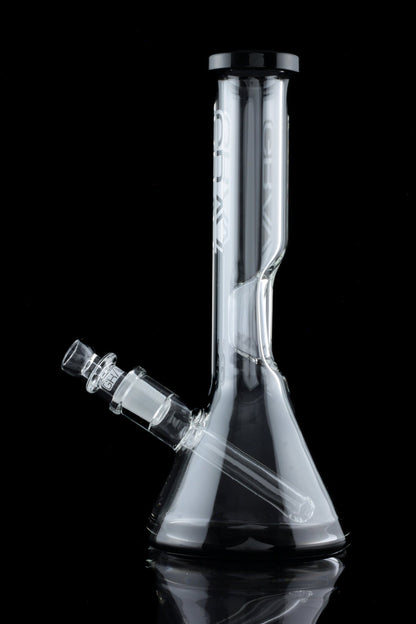 Clear glass bong with ice catch and flared base, reflecting on a black surface.