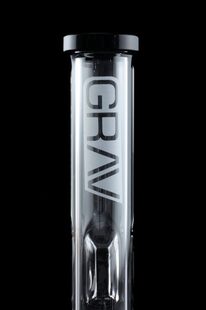 Clear glass bubbler with “GRAV” logo, illuminated against a black background.