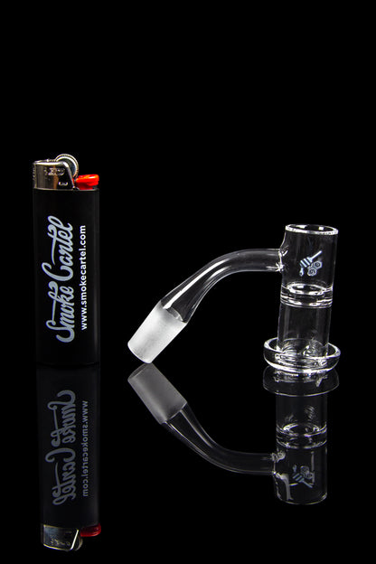 Clear glass water pipe and accessories with a lighter, isolated on a black background.