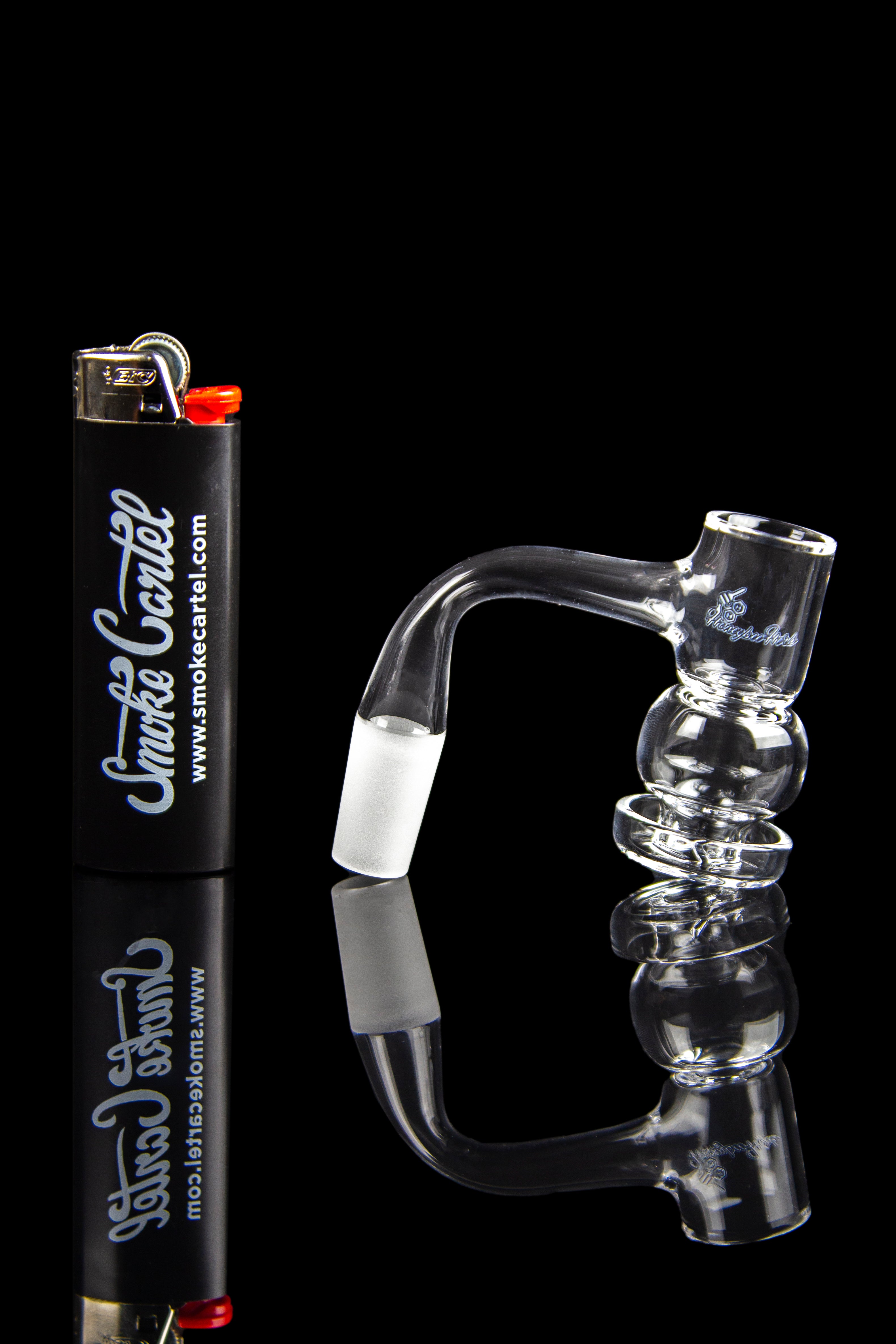 Clear glass water pipe and lighter with branding, studio shot.