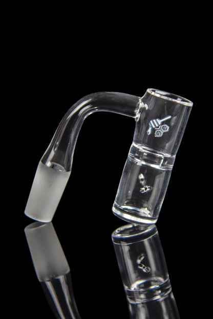 Clear glass bubbler with angled mouthpiece and logo, reflected on a black surface.