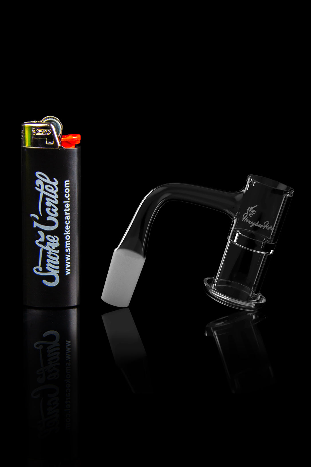 Black glass cannabis water pipe and lighter with “Smoke Cartel” branding reflected on a glossy surface.