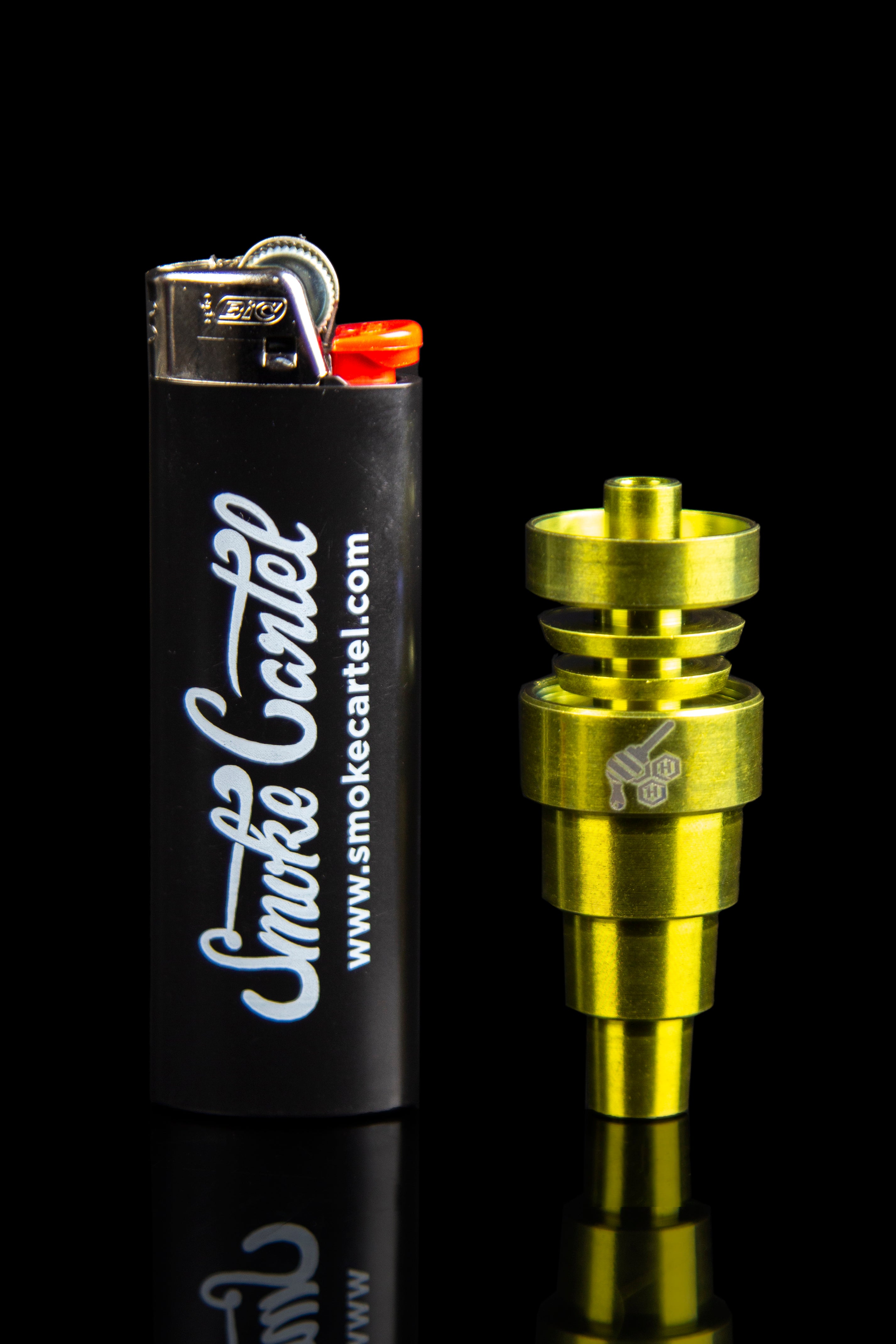Gold-toned oil burner pipe and lighter with “Smoke Cartel” branding.