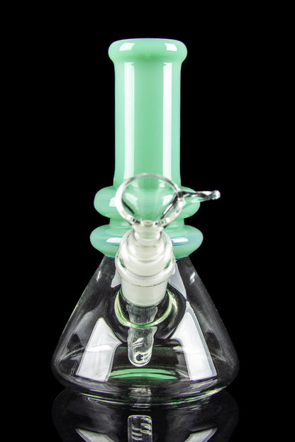 A green and clear glass bong with intricate bubble detailing and a wide base.