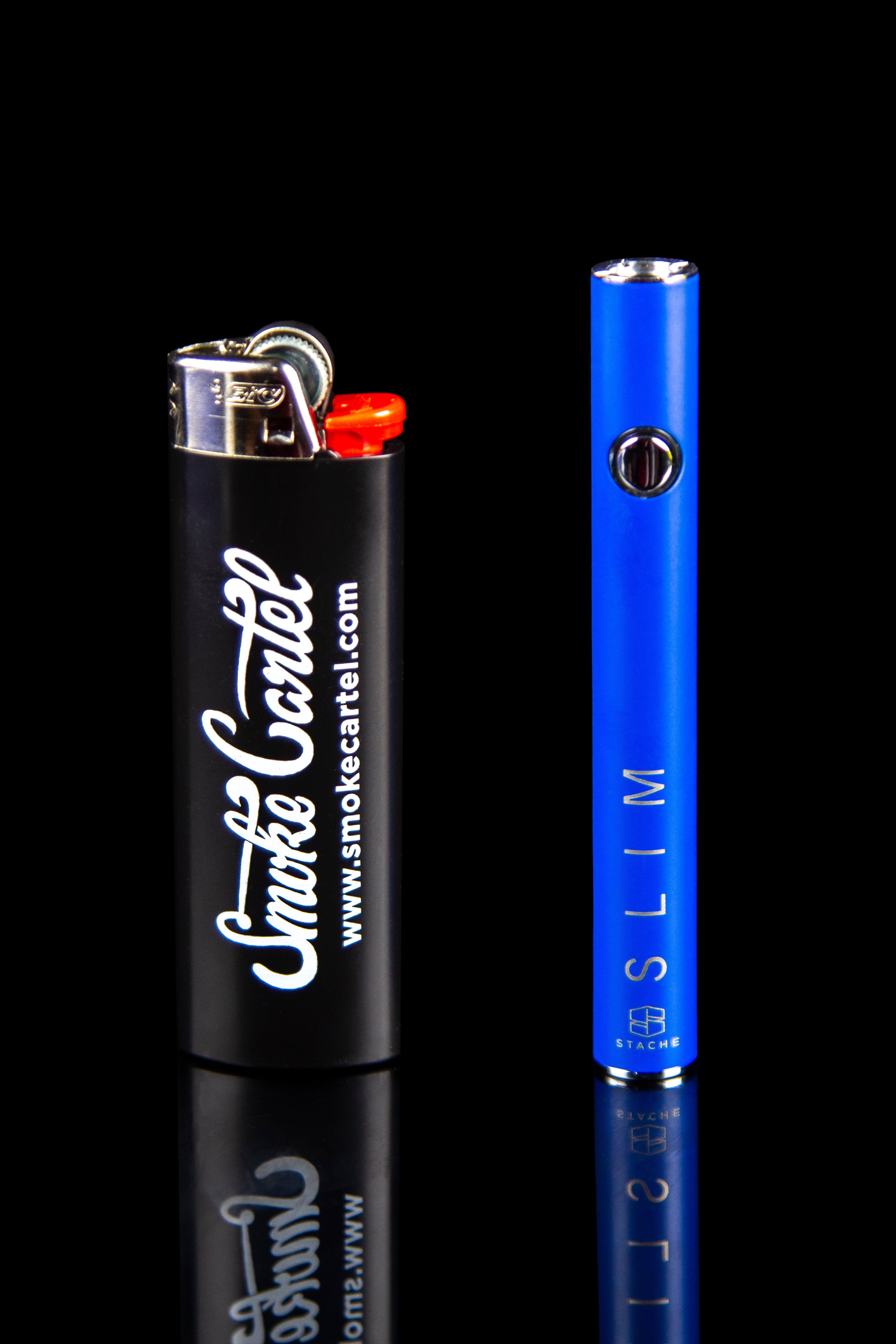 Blue glass pipe and lighter with "Smoke Cartel" branding, reflected on a black surface.