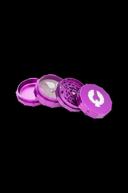 Purple four-piece metal cannabis grinder with a white logo.