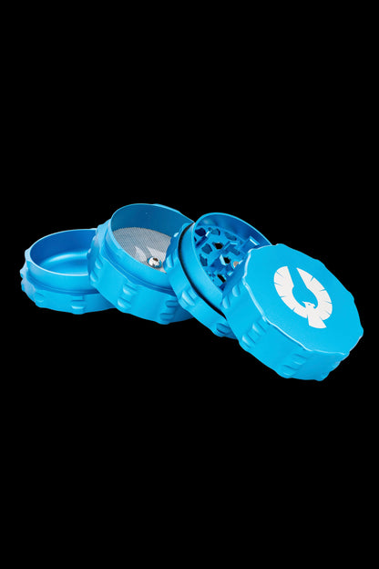 Blue four-piece cannabis grinder with a white horseshoe logo, disassembled to show internal components.