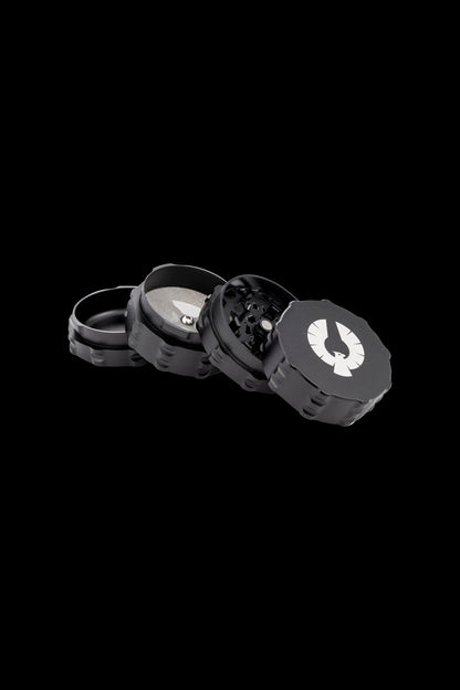Black four-piece cannabis grinder with a white logo.